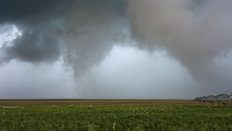 rain clouds moving over agricultural fields and watering system