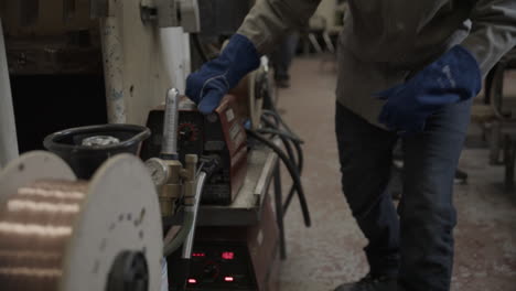 welding student turning on machine