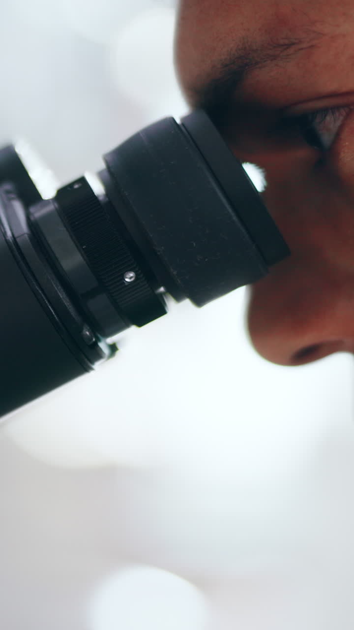 A person looking through a microscope