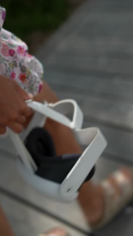 woman wearing vr headset on a wooden deck
