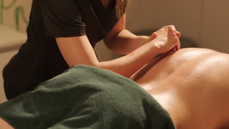 professional massage therapist performing relaxation massage