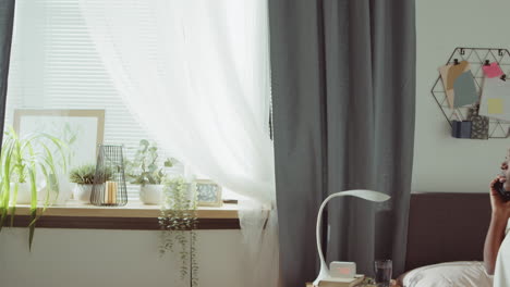 African-American-Woman-Talking-on-Phone-in-Bedroom