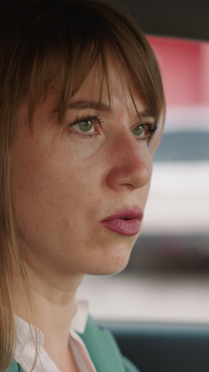 Upset woman looks to sides thinking about problems at work. Depressed businesswoman sits in car cabin preparing to drive home closeup slow motion