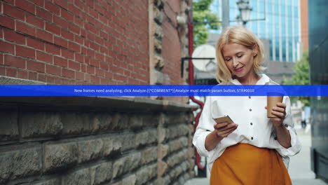 woman using smartphone while enjoying coffee in the city