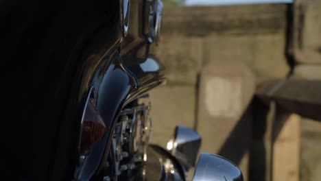 Close-up-of-old-vintage-black-car-tilting-down-shot