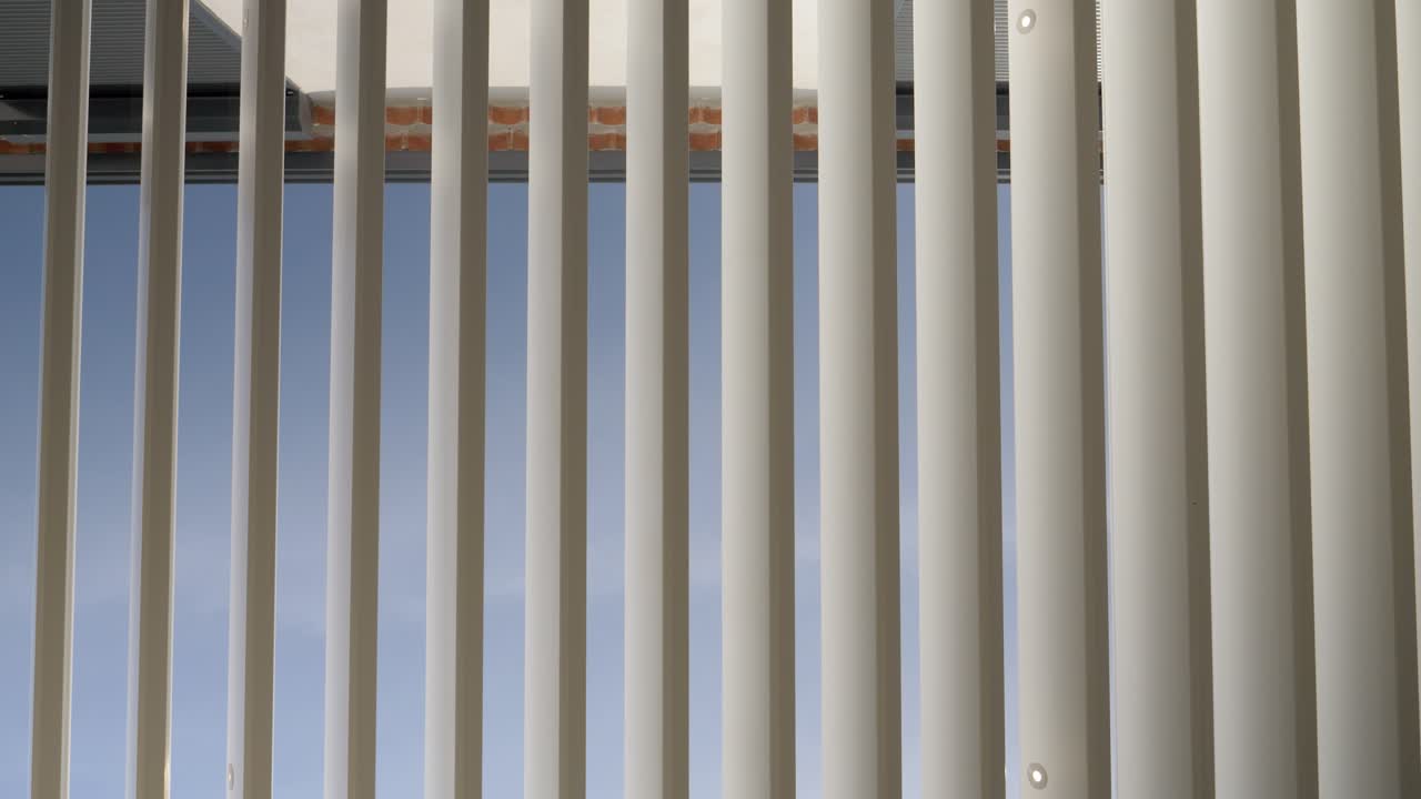 Slow motion shot of blinds opening electronically in a villa bedroom