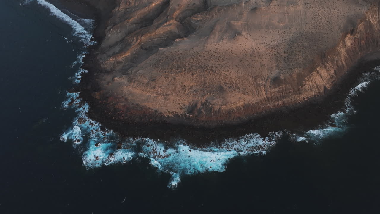 Unknown places in Gran Canaria: Punta de Las Arenas, aerial view of the Atlantic Ocean waves breaking on the rugged volcanic coastline of Gran Canaria