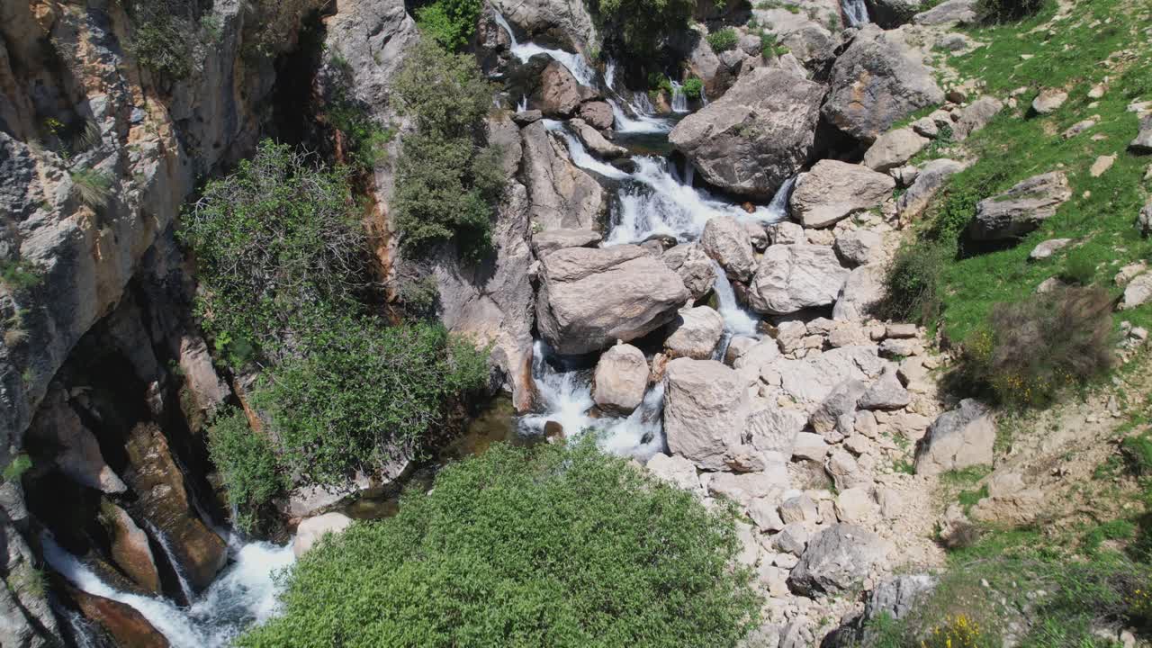 Source of a river among rocks with pure water. Aerial view of the water surface. High mountain spring. Río Castril. Granada. Spain