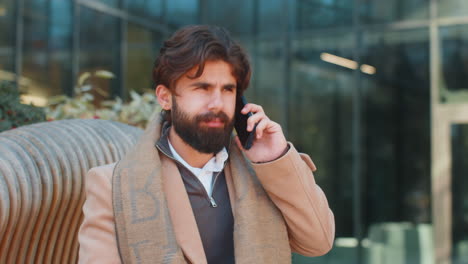 Indian young business man having bad stressful news calling on smartphone unpleasant conversation