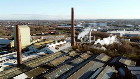 pilkington glass factory warehouse buildings aerial view pan across smokestack rooftop