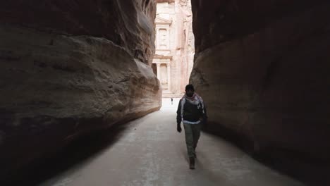 man walking in the siq of petra