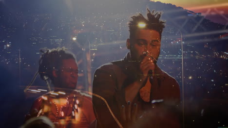 male singer and drummer performing on music stage, with animated cityscape and glowing lights