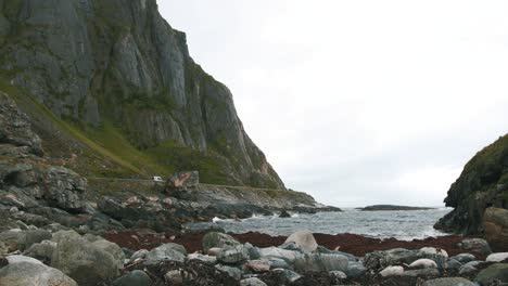 norwegian coastal shore, with a car driving in the distance