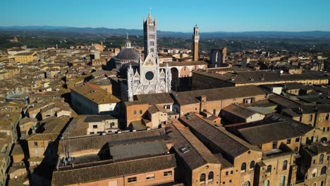 cinematic establishing shot above siena, italy on beautiful day in tuscany