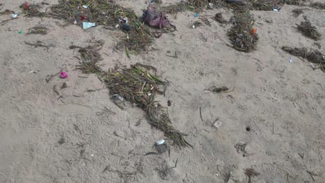 4k video on a sandy beach showing excessive pollution of plastic and general rubbish in chennai, india