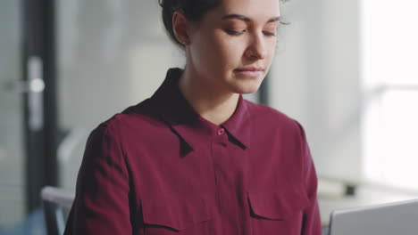 young businesswoman working on laptop in office