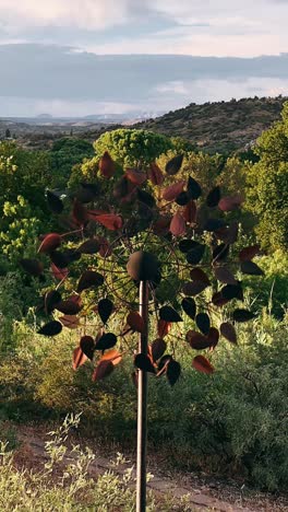 metal leaf windmill in a scenic countryside landscape