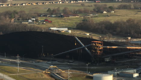 heap of coal and industrial equipment at flint creek power plant - coal-fired power station near gentry in arkansas