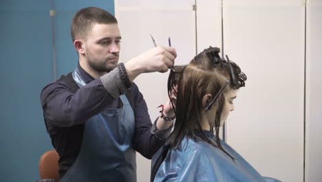 professional hair care. woman cutting her hair in hairdresser salon
