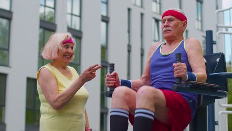 elderly couple working out together outdoors