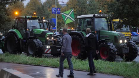tractors on the public road in the hague during the farmers protests against emission regulations. biggest traffic jam caused by farmers in the netherlands. slow motion in sixty frames per second.