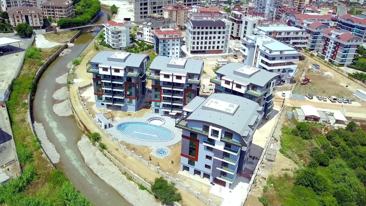 강 근처 에 건설 중 인 현대 아파트 단지 의 공중 사진