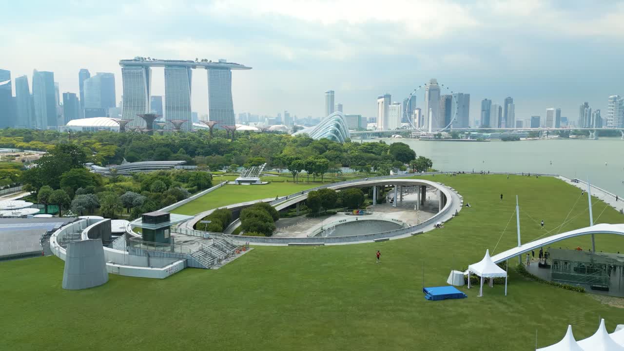 Aerial of Marina Barrage, an impressive engineering marvel and a vital part of Singapore's sustainable development, revealing city skyline on horizon