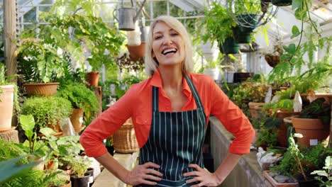 happy mature woman smiling in greenhouse