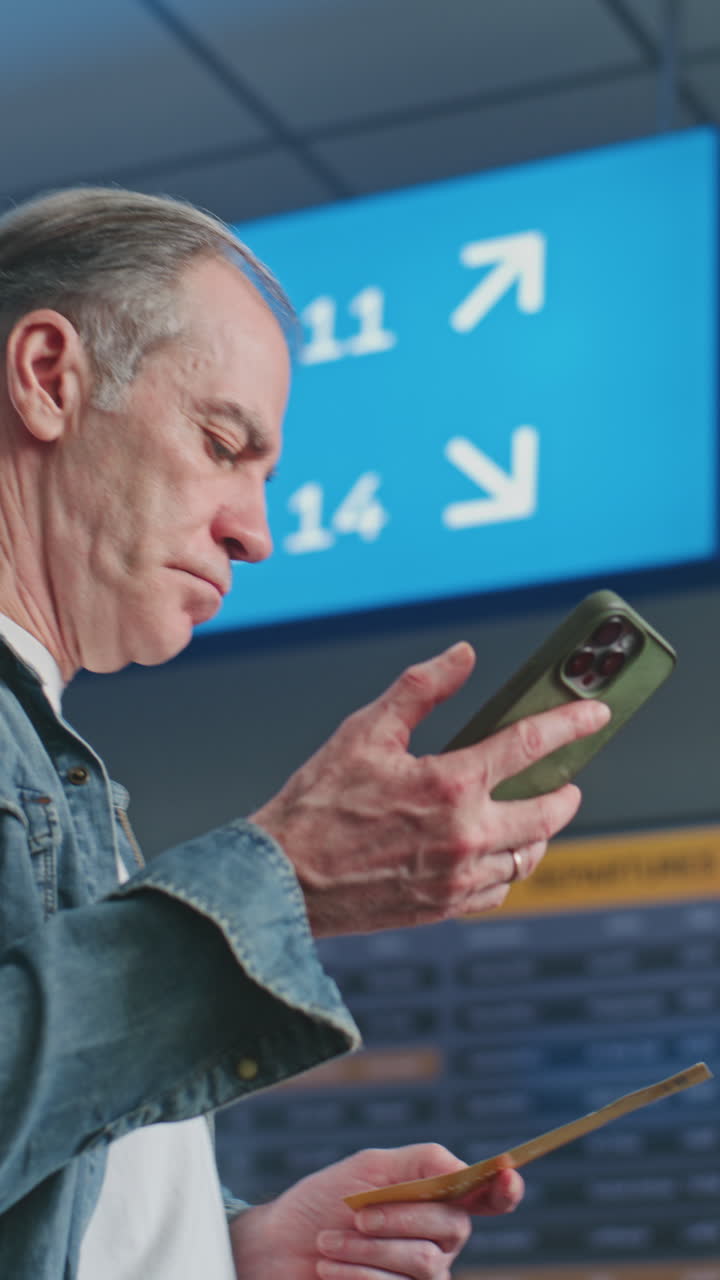 Senior Man Using Smartphone at Airport