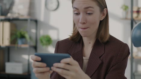 woman playing mobile game in office