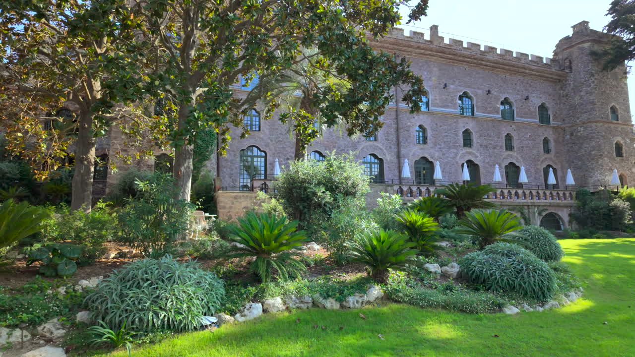 View of the facade of the Chateau de Theoule-sur-Mer surrounded by greenery in France
