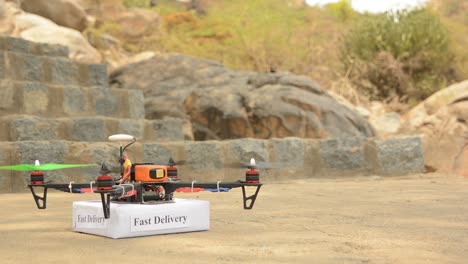 concept product delivery from a drone, custom drone or quadcopter taking off with box from ground