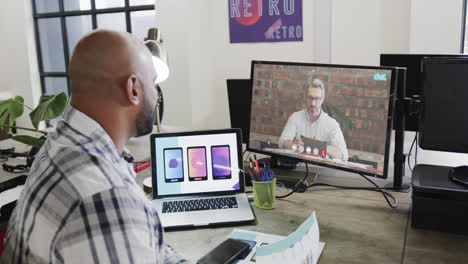 African-american-businessman-on-video-call-with-caucasian-male-colleague-on-screen