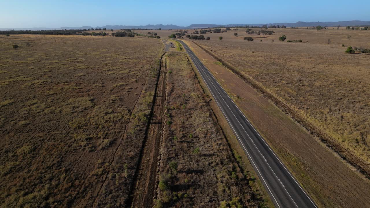 Aerial views of a road through farmland in inland Central Queensland, Australia.