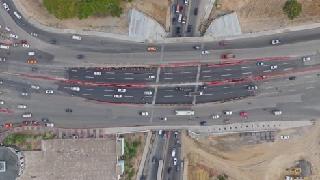 urban elevated road junction and interchange overpass, construction of kilometer 9 of duarte highway, santo domingo city in dominican republic. aerial top-down view