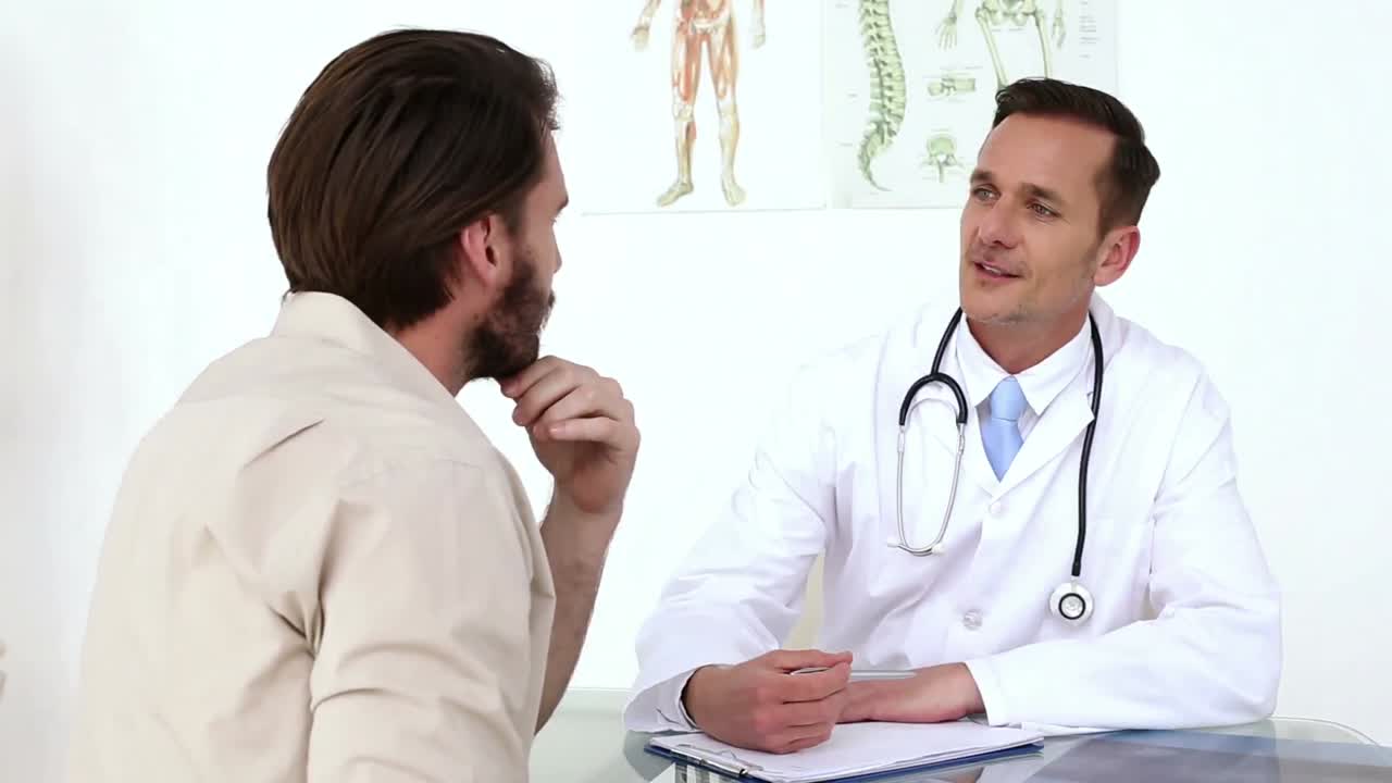 Premium stock video - Doctor showing his patient his xray