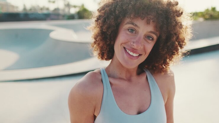 Fit Woman Smiles at Skatepark After Workout