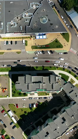 modern cityscape. residential streets and cars between apartment building rooftops. traffic and parking places in the city. top view. vertical video