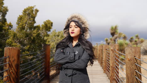 Pretty-woman-looking-serious-walking-on-a-bridge-under-a-rain-storm-and-cloudy-sky-SLOW-MOTION