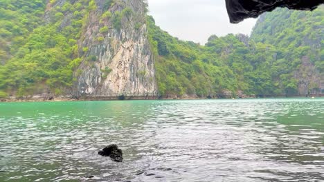 Cruising-out-of-Dark-and-Light-Cave-in-Lan-Ha-Bay-and-Ha-Long-Bay-area-in-Vietnam-in-sampan-fishing-boat