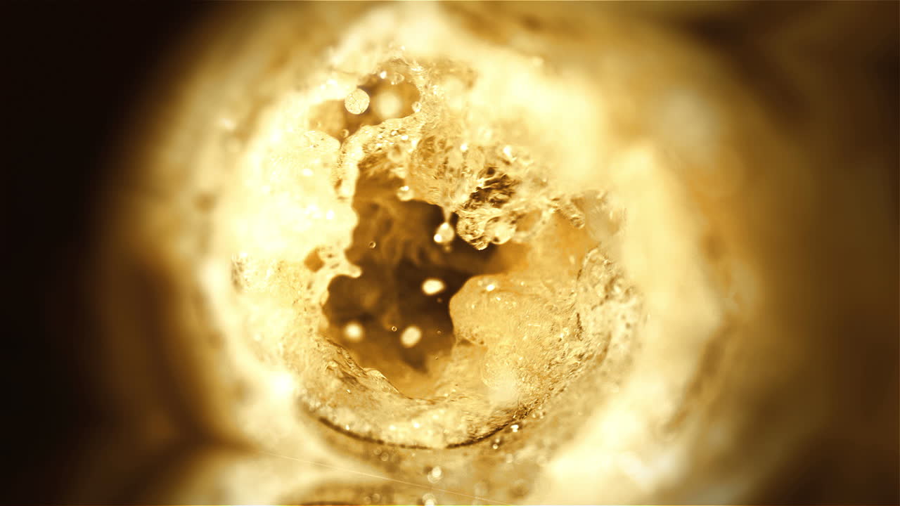 Beer is pouring from the top into the glass forming waves-5