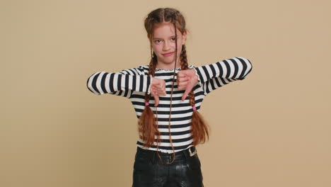 upset preteen child girl showing thumbs down dislike bad work disapproval dissatisfied feedback