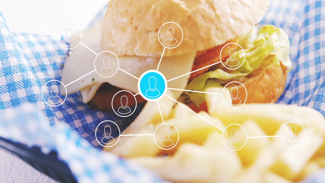 Burger and fries with animated network connections overlay in restaurant setting