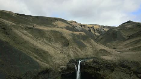 Iceland-Drone-Green-Hills-and-Canyon-with-Waterfall-Kvernufoss