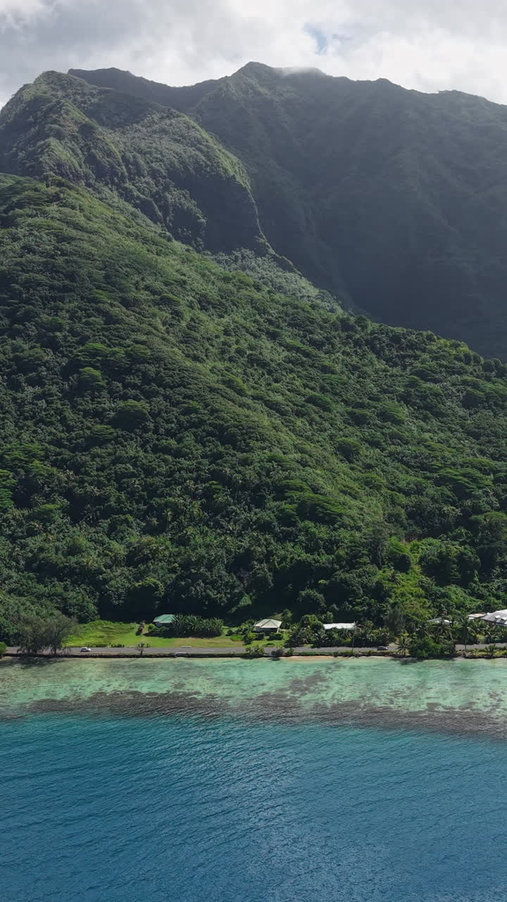 Vertical Drone Shot of Moorea Island, French Polynesia. Coastal Road and Rainforest on Volcanic Hills
