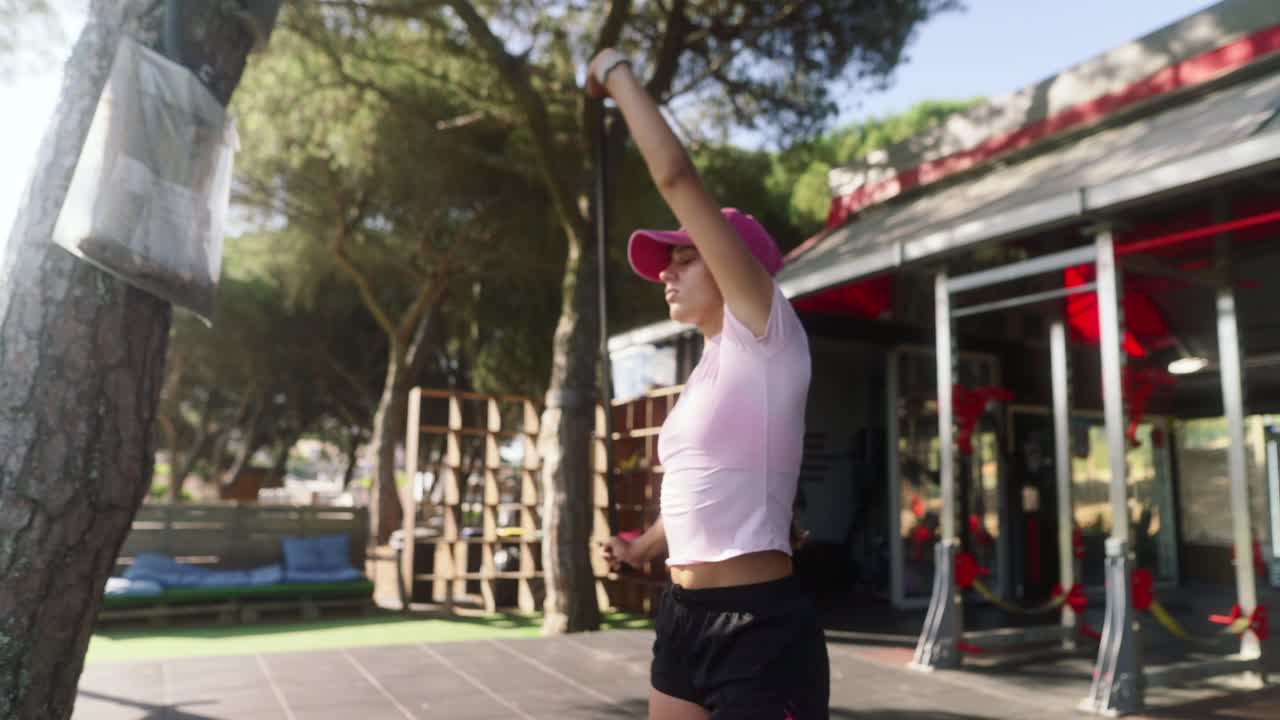 Young Woman Working Out with Resistance Band Outdoors