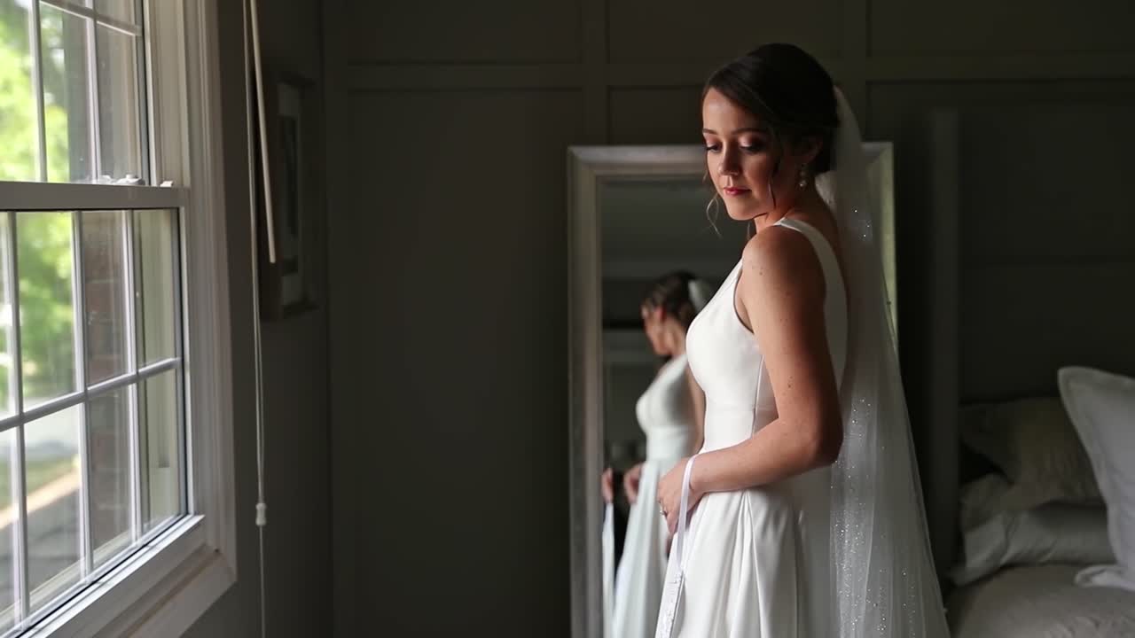 Bride Looks At Her Wedding Dress On Summer Wedding Day
