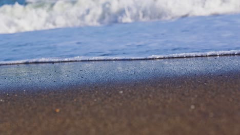 Close-up-of-beach-waves-foam-in-slow-motion