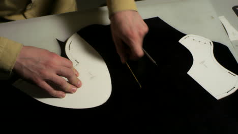 man working with leather using crafting tools. leather crafting atelier