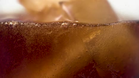 slow motion extreme close up soft drink pouring in glass